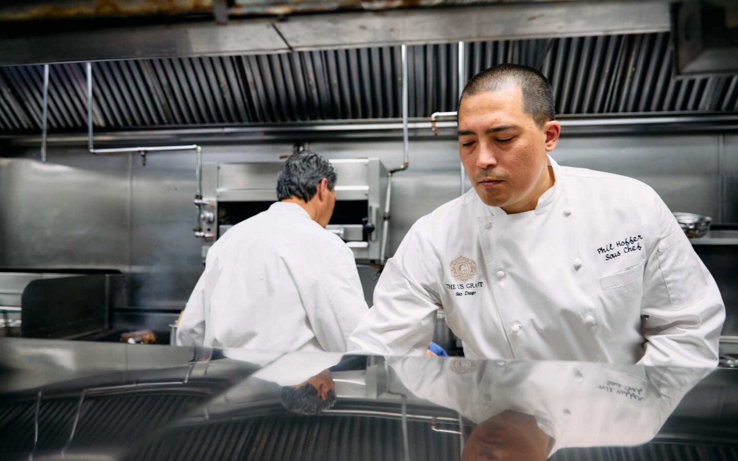 Chefs collaborating in a restaurant kitchen.