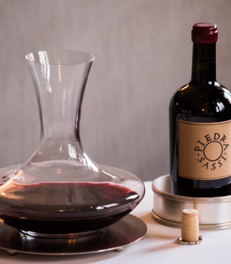 Wine decanter and bottle on table with cork