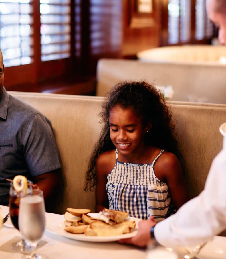 a family being served in a restaurant