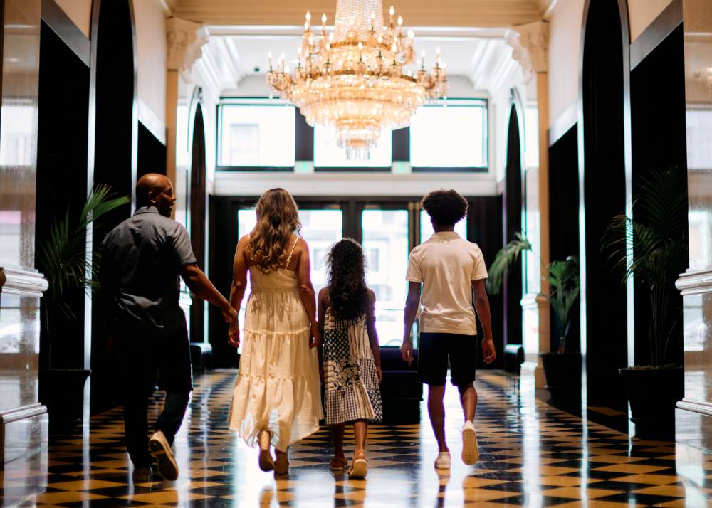 a family walking down a hall holding hands