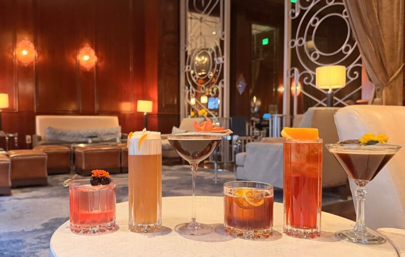 Assorted craft cocktails displayed on a table in an elegant lounge setting.